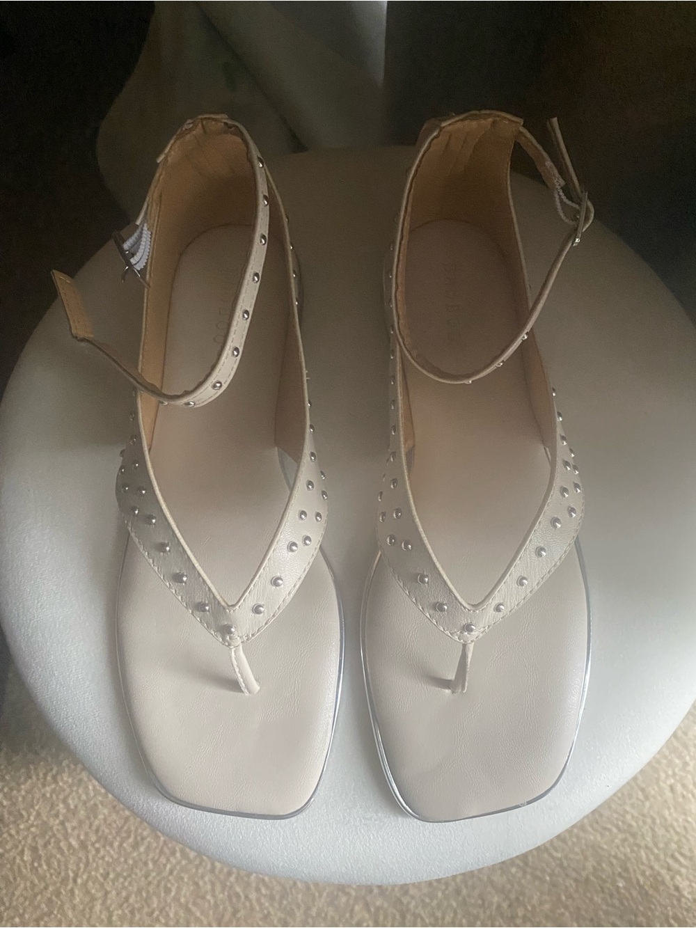 Studded Ankle-Strap Thong Sandals in Beige